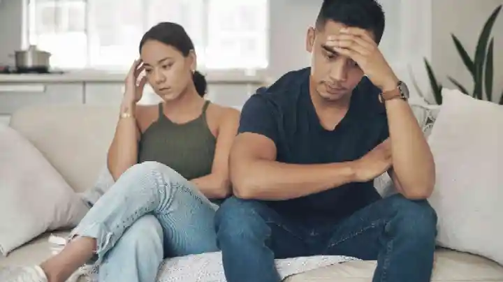 Married couple sitting silently showing emotional distance in marriage