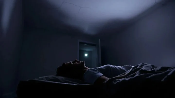 Husband lying awake at night overthinking silence in marriage