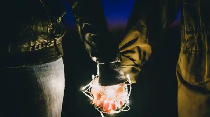 Couple holding hands at night symbolizing emotional connection in marriage